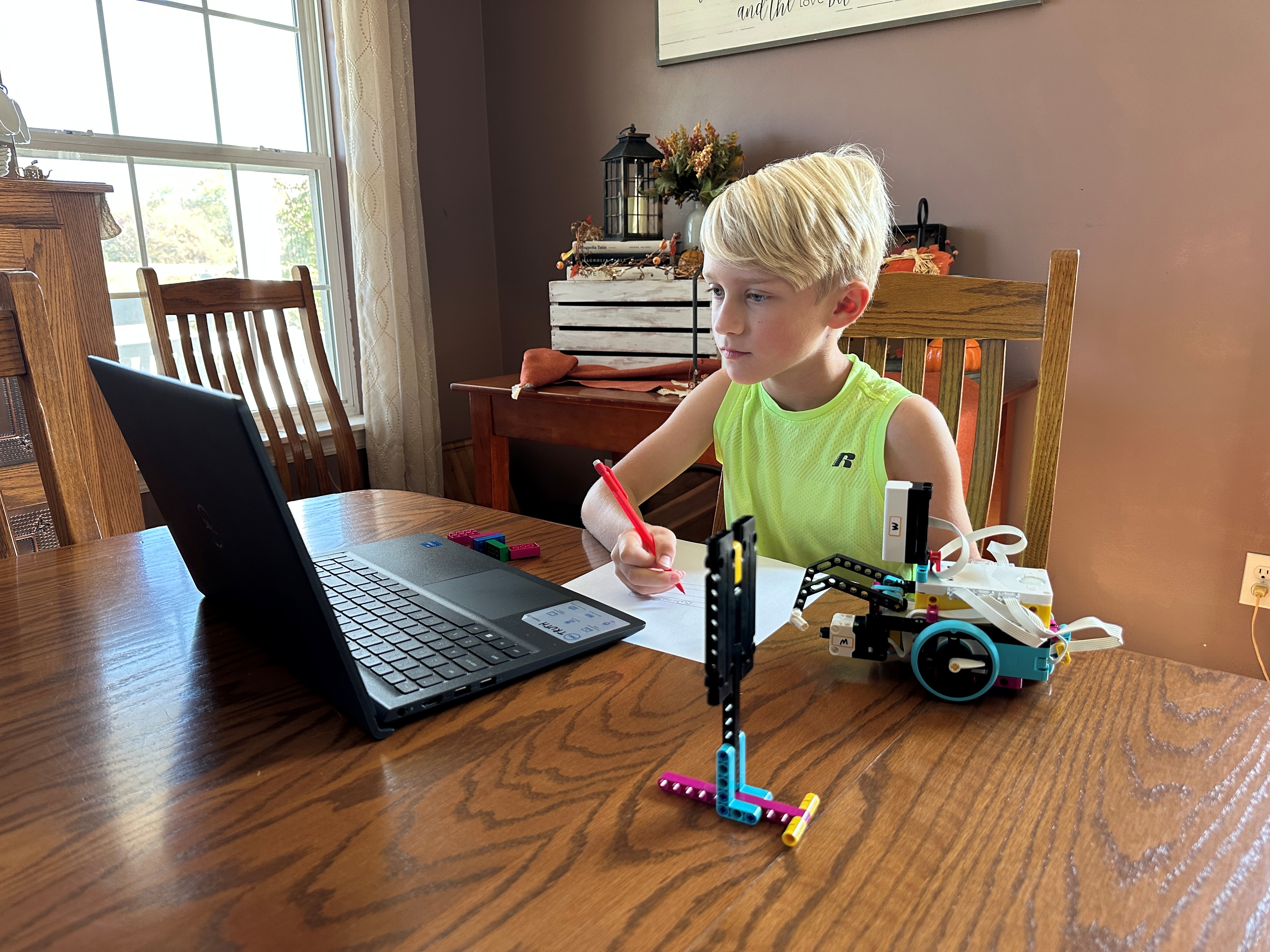 Child coding with LEGO robot